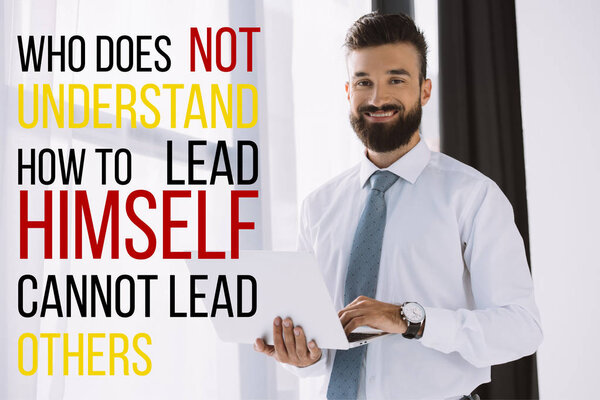 bearded smiling businessman using laptop near window with "who does not understand how to lead himself cannot lead others"