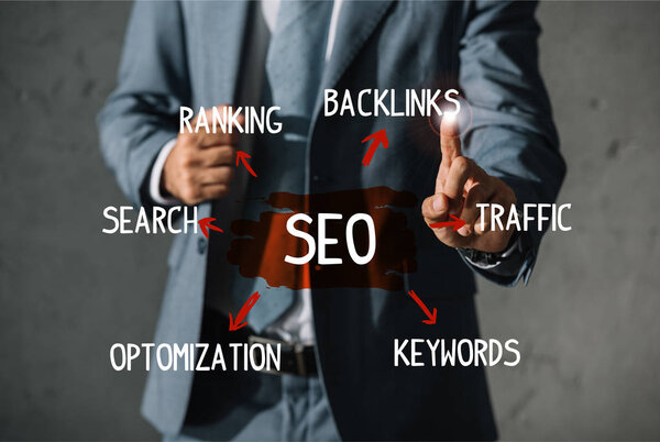 обрезанный взгляд разработчика в формальной износа указывая на SEO идеи и план
