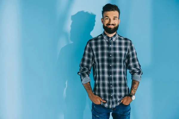 Bearded Smiling Man Checkered Shirt Standing Hands Pockets Blue — Stock Photo, Image