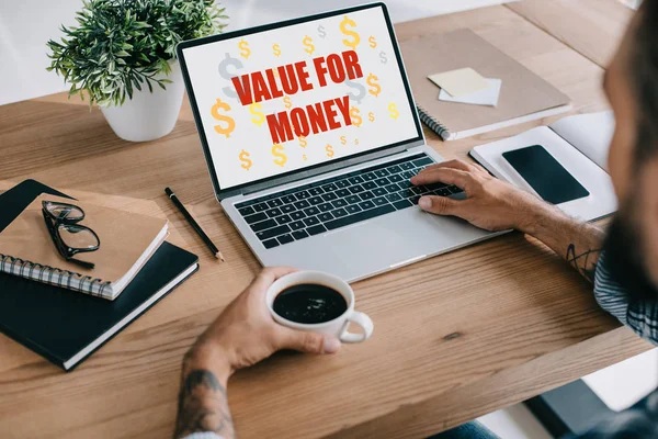 Cropped View Businessman Using Laptop Value Money Lettering Holding Cup — Stock Photo, Image