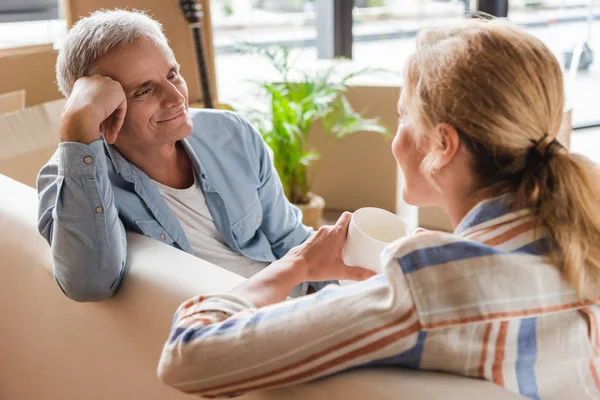 Happy Senior Couple Sitting Couch Smiling Each Other While Relocating — Stock Photo, Image