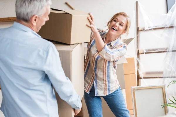 Happy Senior Couple Holding Cardboard Boxes While Moving Home — Stock Photo, Image