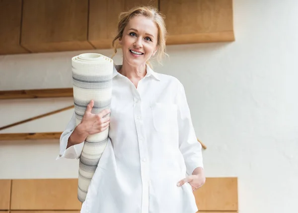 Beautiful Happy Mature Woman Holding Yoga Mat Smiling Camera — Free Stock Photo