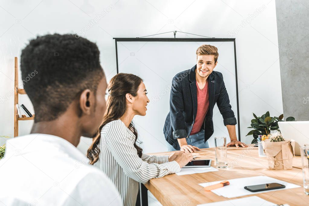 multiethinc business coworkers having conversation during conference in office