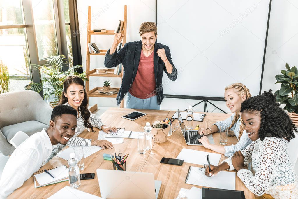 multicultural happy business team having conference at workplace in office