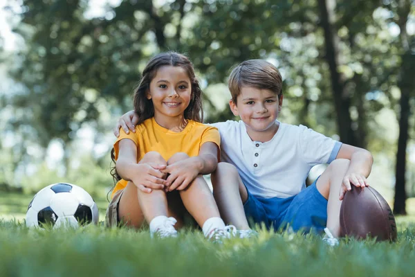 Cute Happy Kids Soccer Rugby Balls Sitting Grass Smiling Camera — Stock Photo, Image