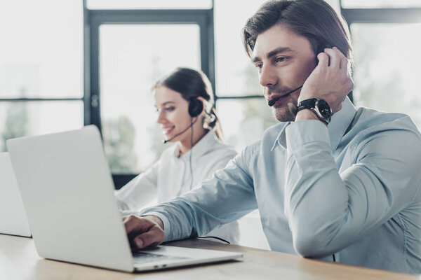 male and female call center managers working together at modern office