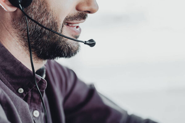 cropped shot of call center worker with microphone