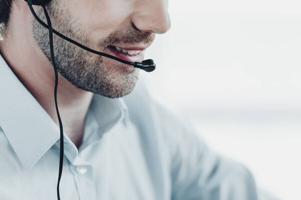 cropped shot of smiling support hotline manager at work