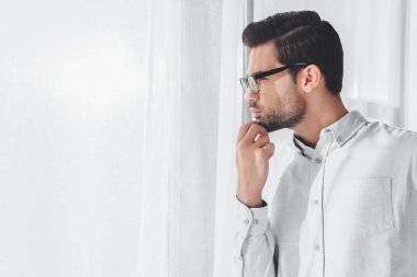 side view of thoughtful handsome businessman looking away clipart