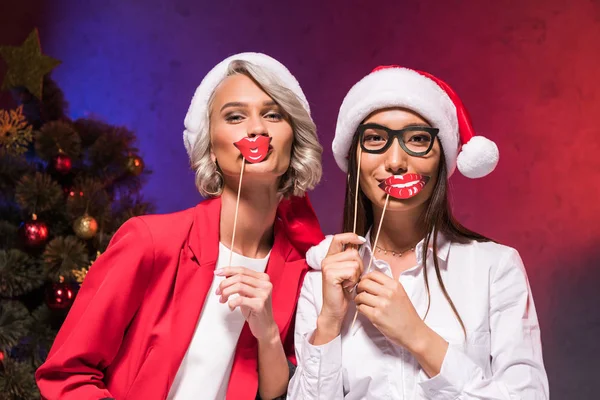 Multicultural Businesswomen Santa Hats Holding Fake Lips Sticks New Year — Stock Photo, Image