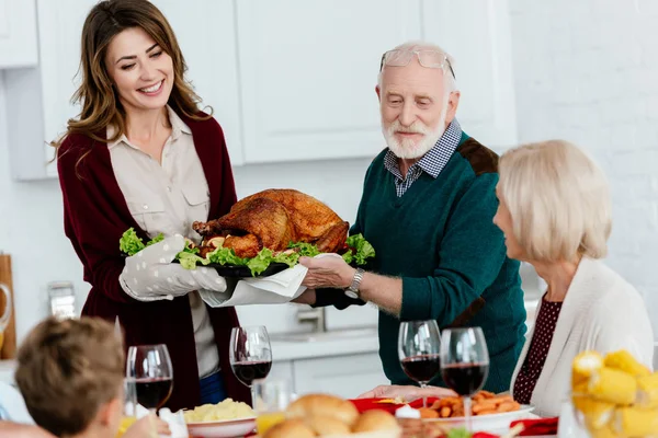 Äldre Man Och Vuxen Kvinna Bär Bakade Turkiet För Thanksgiving — Stockfoto