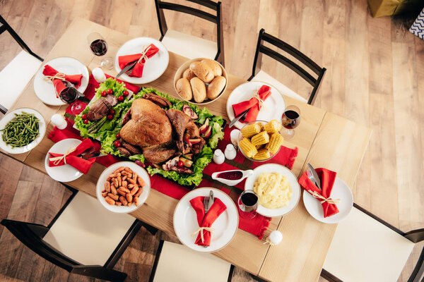 top view of served table with delicious dishes and wine for holiday dinner on thanksgiving 