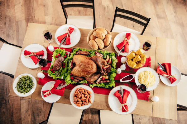 elevated view of served table with delicious dishes and wine for holiday dinner