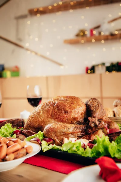 selective focus of delicious baked turkey on served table for holiday dinner on thanksgiving day