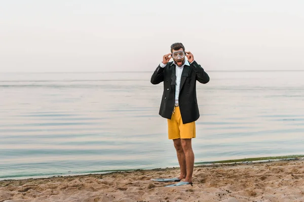 Schockierter Mann Schwarzer Jacke Kurzer Hose Und Schwimmflossen Mit Bademaske — kostenloses Stockfoto