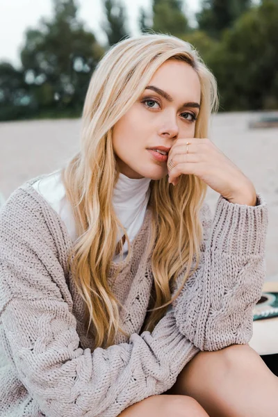 Attractive Blonde Woman Autumn Outfit Sitting Beach Touching Lips Looking — Stock Photo, Image