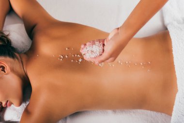 cropped view of woman having salt therapy at spa salon 