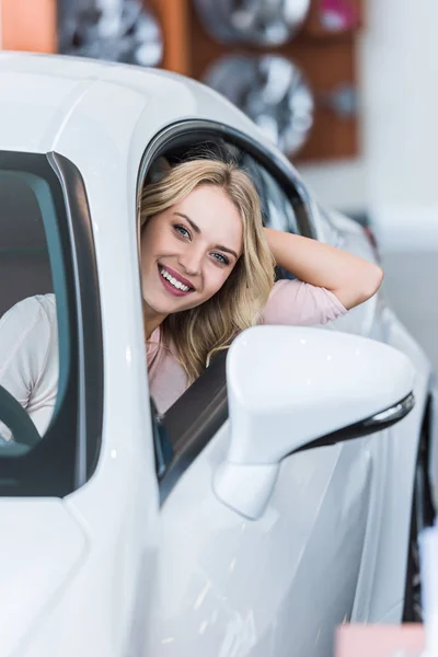 Portrait Happy Young Woman Sitting New Car Dealership Salon — Stock Photo, Image