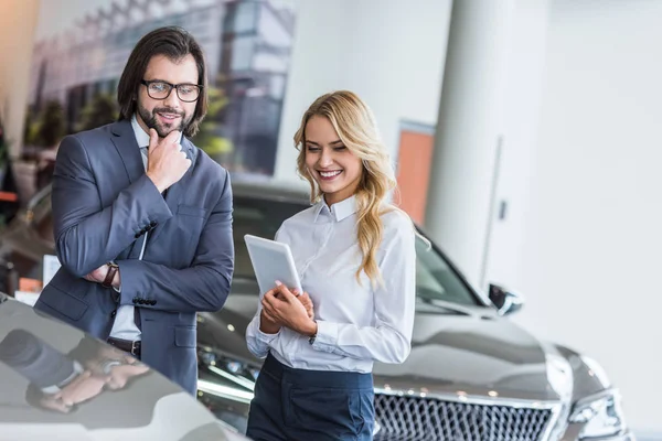 Smiling Female Auto Salon Seller Tablet Helping Businessman Choose Car — Stock Photo, Image