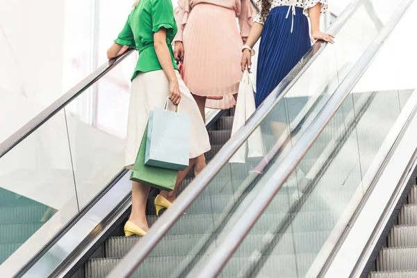 Cropped Shot Young Women Shopping Bags Standing Escalator — Free Stock Photo
