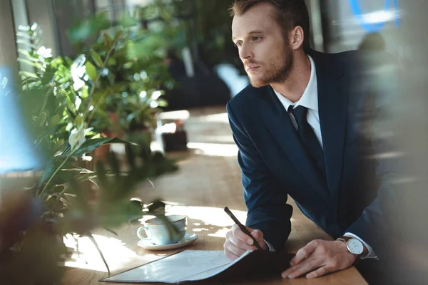 Pensive Businessman Looking Away While Doing Paperwork Table Cup Coffee — Stock Photo, Image