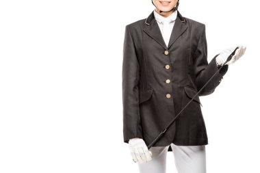 cropped shot of smiling young horsewoman in uniform holding horseman stick isolated on white clipart