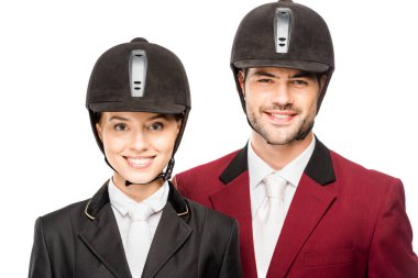 close-up portrait of smiling young equestrians in uniform and helmets looking at camera isolated on white clipart