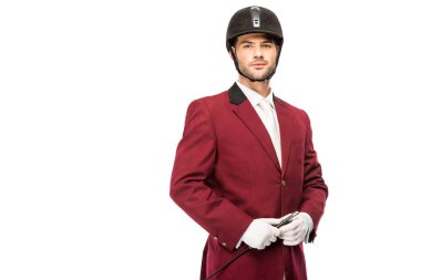 handsome young horseman in uniform and helmet looking at camera isolated on white clipart
