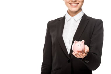 cropped shot of smiling businesswoman holding piggy bank isolated on white clipart
