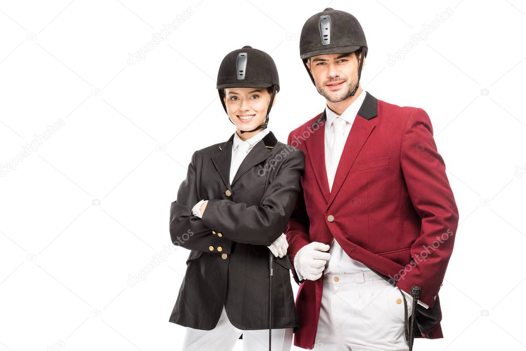 successful young equestrians in uniform and helmets looking at camera isolated on white