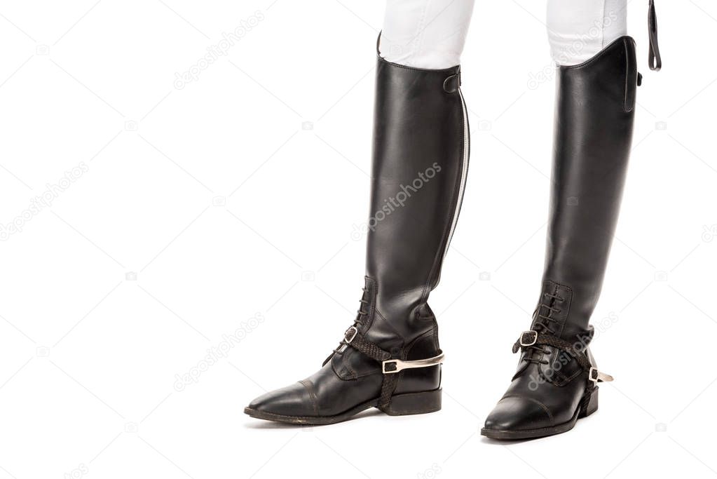 cropped shot of horsewoman standing in leather boots isolated on white