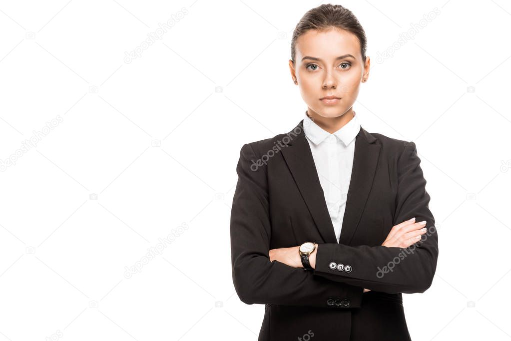 young businesswoman in jacket looking at camera with crossed arms isolated on white