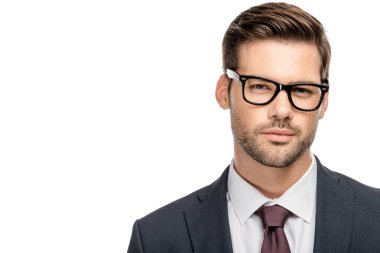 portrait of handsome young businessman in eyeglasses looking at camera isolated on white clipart