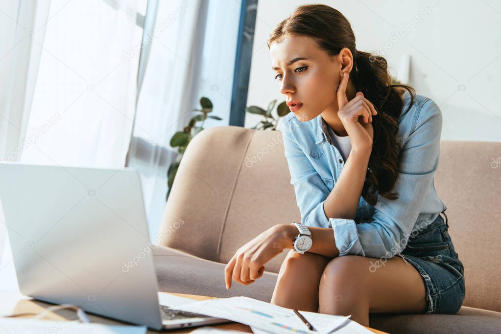 focused businesswoman taking part in webinar at home