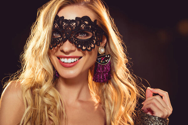 attractive cheerful girl in black masquerade mask