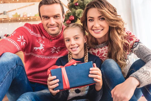 Sonrientes Padres Hija Con Navidad Presente Mirando Cámara Casa — Foto de Stock