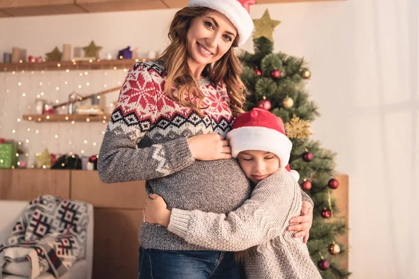 Dcera Santa Hat Pûdû Těhotná Maminka Poblíž Vánoční Stromeček Doma — Stock fotografie