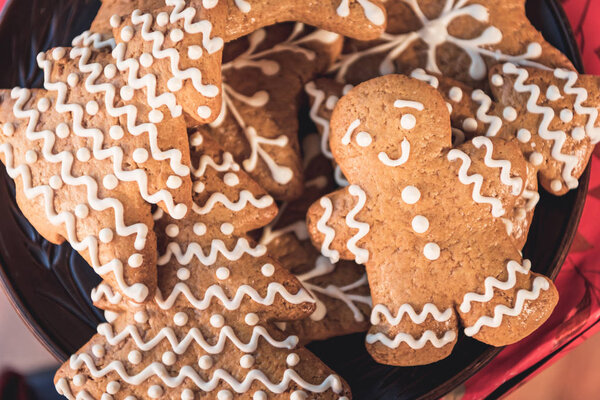 close up of sweet christmas cookies and gingerbread man with icing