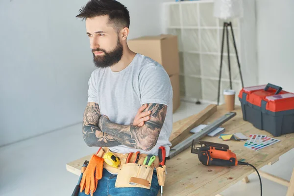 Side View Pensive Bearded Repairman Tattoos Tools Leaning Wooden Surface — Stock Photo, Image