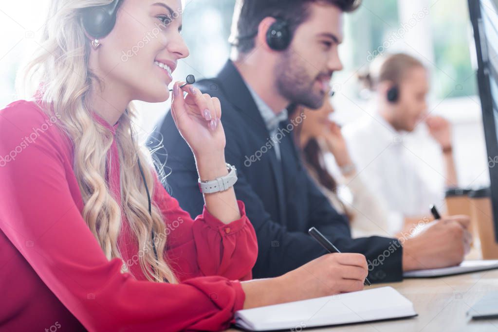 selective focus of call center operators working at workplace in office