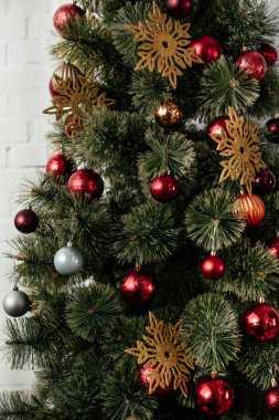 baubles ve oda içinde altın kar taneleri ile Noel ağacı
