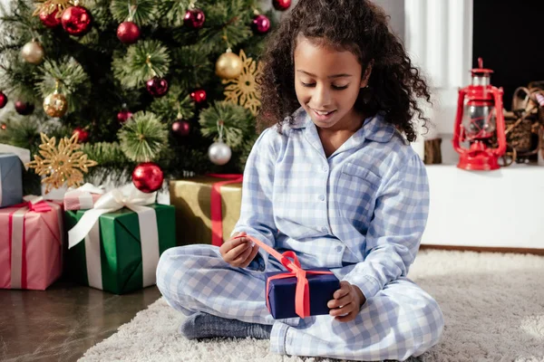 Excited Adorable African American Child Pajamas Opening Christmas Gift Home — Stock Photo, Image