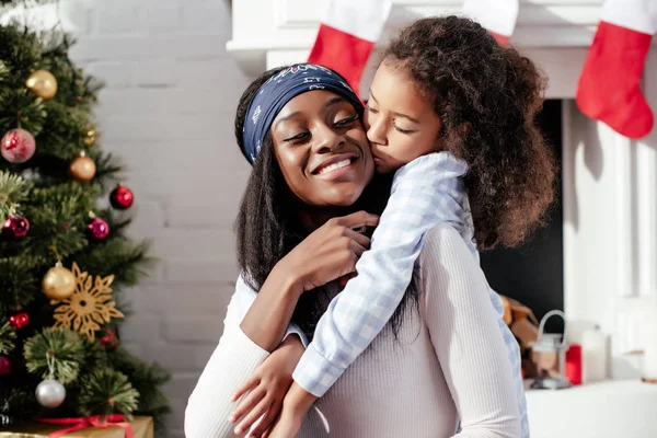 Adorable African American Daughter Kissing Mother Home Christmas Concept — Stock Photo, Image