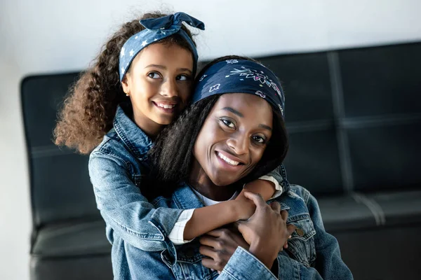 Schattige Afro Amerikaanse Jongen Knuffelen Lachende Moeder Soortgelijke Kleding Thuis — Stockfoto