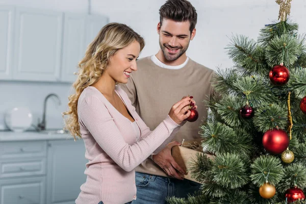 Happy Girlfriend Boyfriend Decorating Christmas Tree Baubles Together Preparing Holiday — Stock Photo, Image