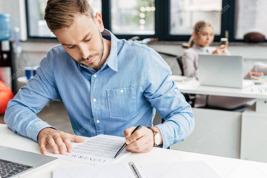 young businessman working with contract in office