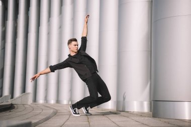 young man performing contemporary dance on street clipart