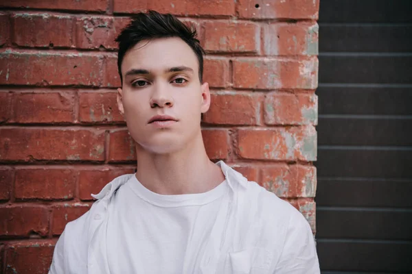 Portrait Handsome Young Man Standing Brick Wall Looking Camera — Stock Photo, Image