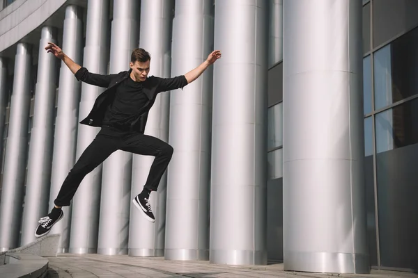 Handsome Young Man Black Clothes Jumping Dancing Street — Free Stock Photo